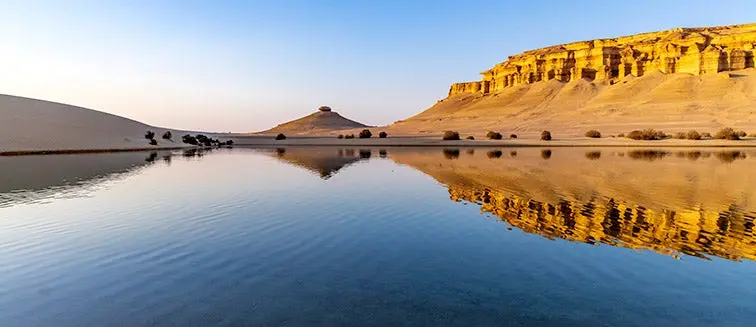 Pyramid and temple ruins reflected in a pool at Al-Fayoum