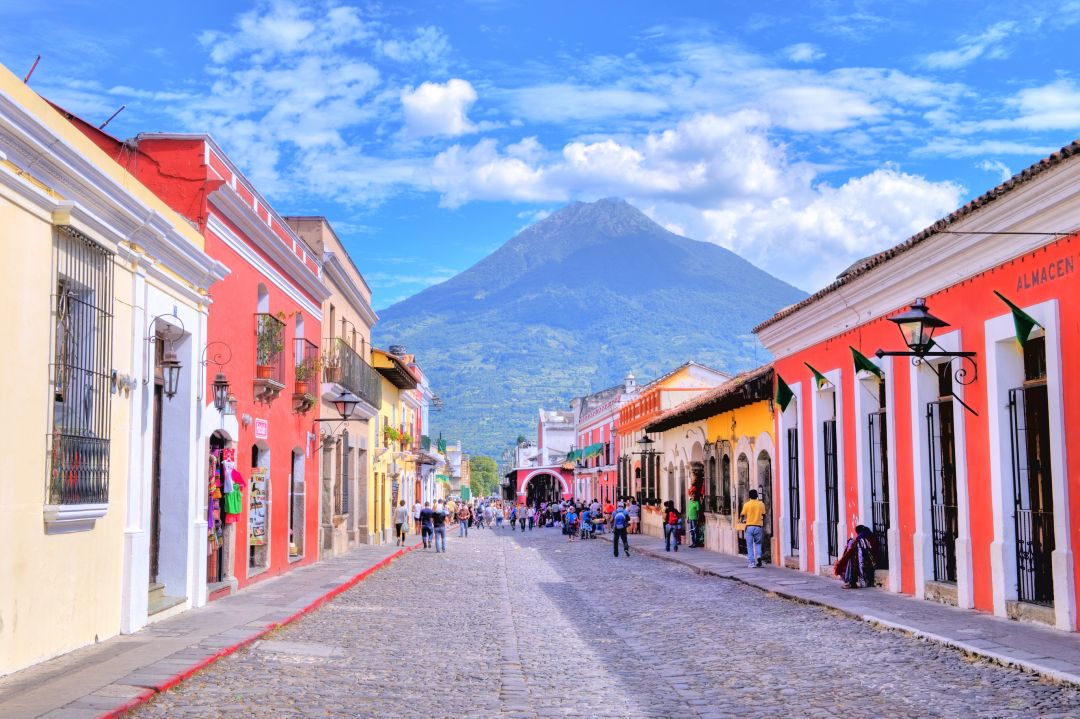Colorful colonial street beneath a volcano in Guatemala